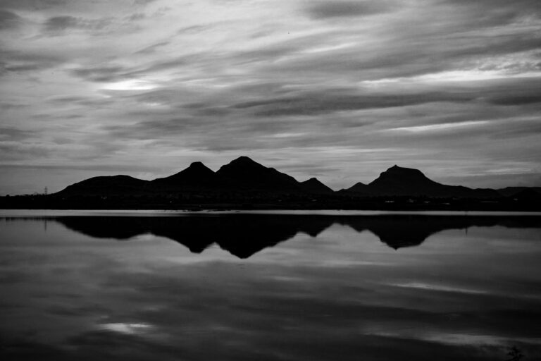 Symmetric reflection of hills in a lake